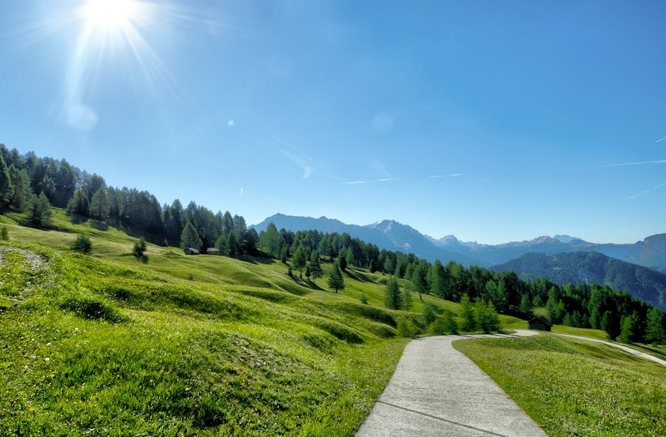 Majestic mountain expedition with climbers traversing a sunlit alpine ridge against dramatic snow-capped peaks